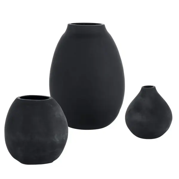 A set of three matte black glass vases in varied sizes, offering an easy way to add cozy, organic texture to shelves, mantels, and tabletops.