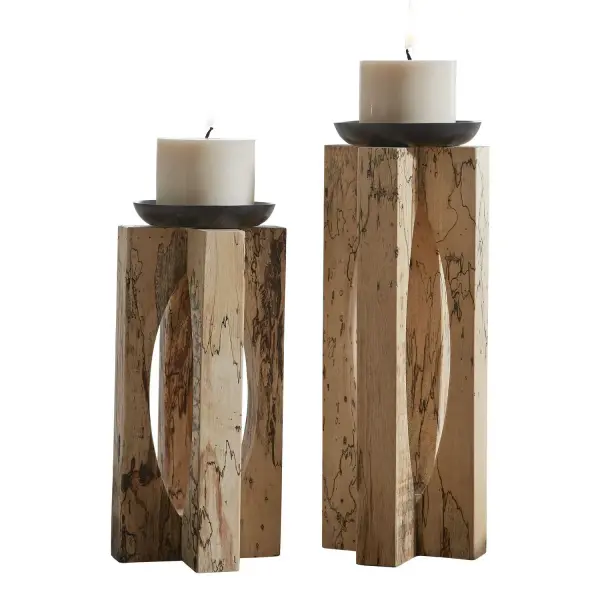 A set of two natural tamarind wood candleholders with satin black candle cups, showcasing organic grain patterns for warm, sculptural table styling.