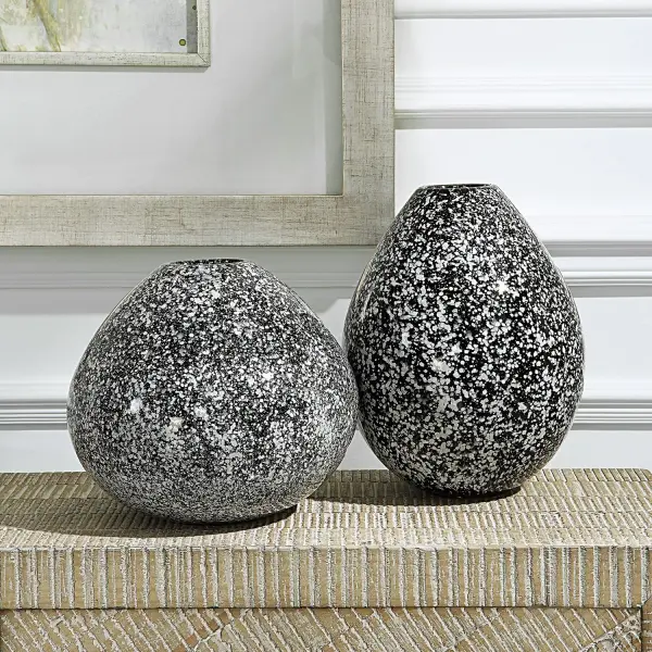 This set of two ceramic vases pairs classic black and white for a versatile decorative accent that suits many interior styles.