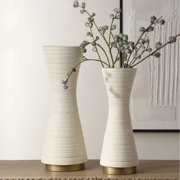 A textured white ceramic vase set with antique gold metal bases, offering understated luxury for shelves, tables, or mantels in any transitional space.