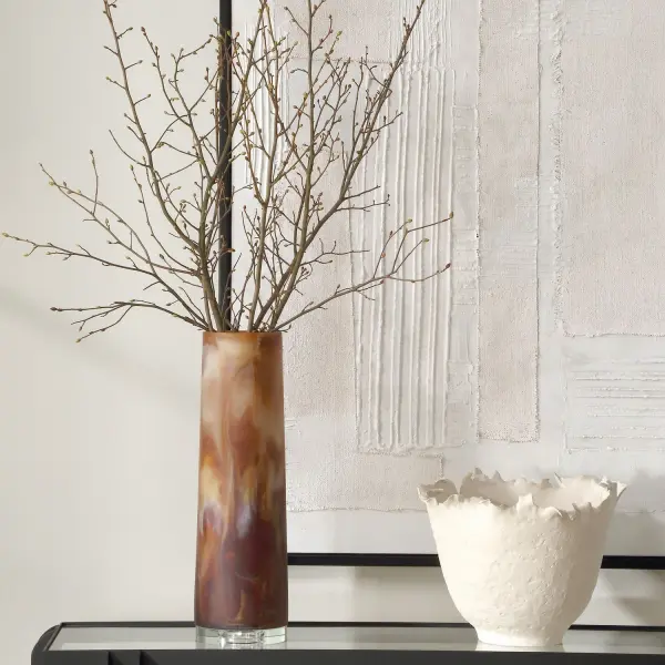 This resin and glass vase blends earthy caramel-brown swirls with an elegant crystal base, adding sculptural warmth to any tabletop vignette.