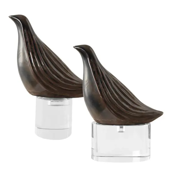 A set of two gunmetal gray bird sculptures perched on crystal bases, offering an elegant contrast of matte metal-look finish and sparkle for shelves and tables.
