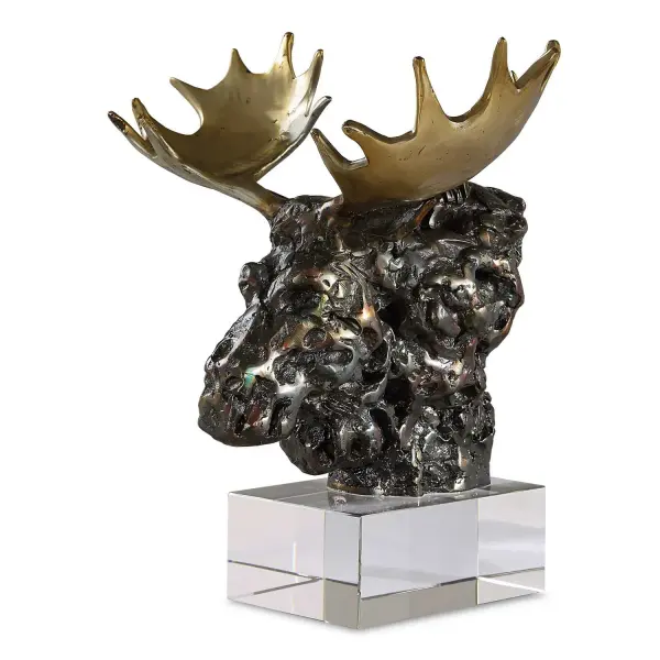 This tabletop moose bust blends tarnished bronze and gold antler accents atop a crystal base, delivering a lodge-inspired accent piece with unexpected sparkle.