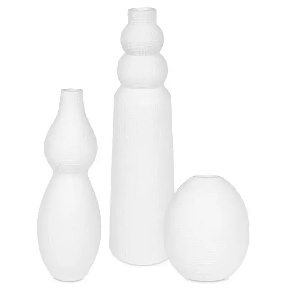 A set of three artfully shaped white ceramic vases that bring contemporary texture to shelves, tables, or outdoor patios year-round.
