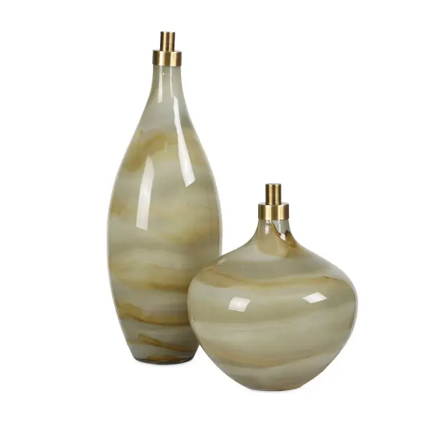 This set of two glass bottles blends soft swirled grays, caramels, and ivories with antique brass toppers for an elegant decorative accent piece.
