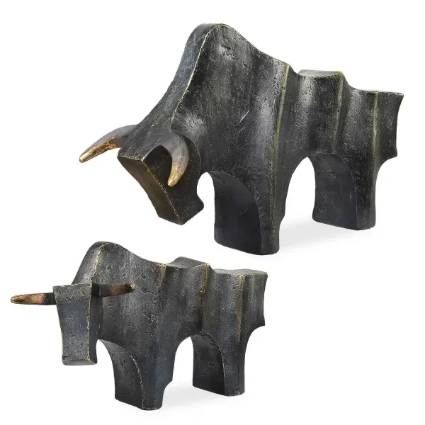A dark bronze and gold pair of bull sculptures that brings dynamic, sophisticated character to shelves, consoles, or desks.