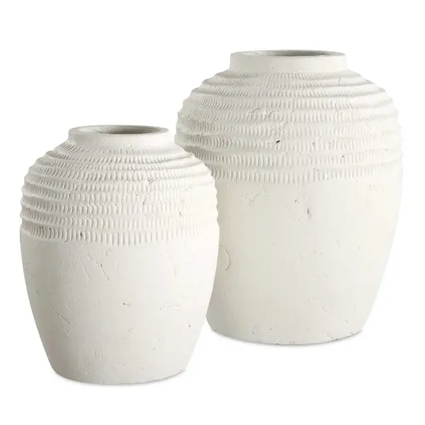 This set of two chalk white ceramic vases offers understated, artisanal texture that pairs well with modern or organic interiors, whether styled with florals or displayed alone.