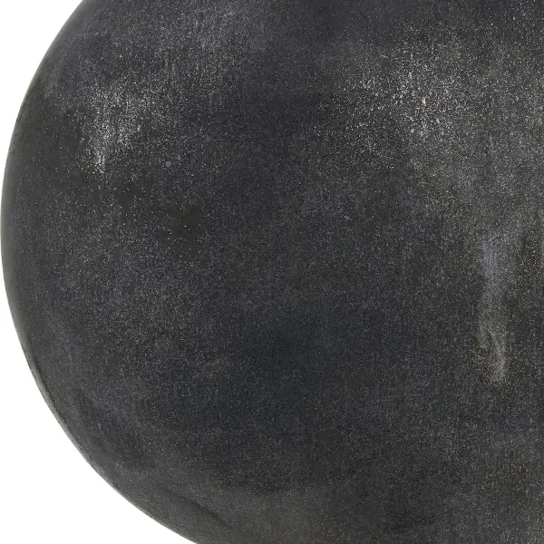 This set of three ceramic vases offers a worn, minimalist aesthetic with a distressed black finish suited to both indoor and outdoor display.