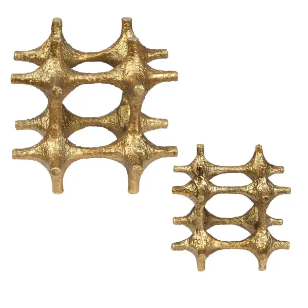 A pair of multi-pointed antique brass sculptures that add sophisticated texture to shelves or console tables in modern or eclectic interiors.