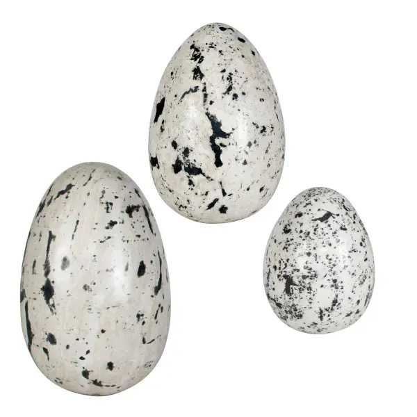 A set of three hand-polished stone eggs with natural speckled patterning in beige and charcoal. Versatile decor for indoor or covered outdoor display.