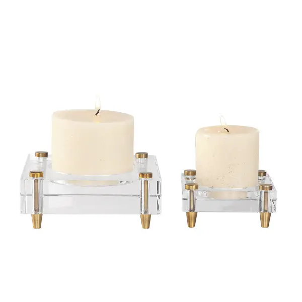 A refined set of two heavy crystal candleholders raised on machined brass legs, ideal for adding sculptural warmth to tabletops and mantels.