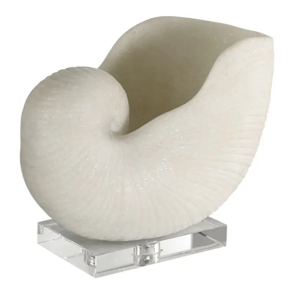 This oversized nautilus shell sculpture brings an organic, coastal touch to shelves and tabletops with a convincing faux-marble finish and crystal base accent.