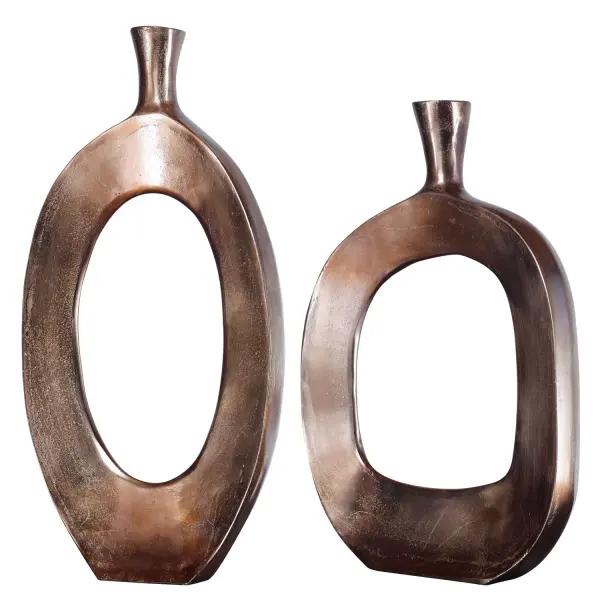 An over-sized pair of textured cast aluminum vases in a golden bronze finish, handcrafted in India for organic-modern styling on consoles, mantels, or entry tables.