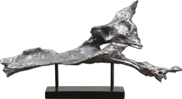 A tabletop sculpture pairing heavily antiqued silver resin with a matte black iron stand, offering an artisanal decorative accent for shelves and consoles.