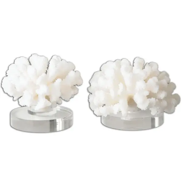 A set of two textured cream resin coral sculptures with crystal bases, bringing organic coastal texture to shelves, consoles, or mantels.
