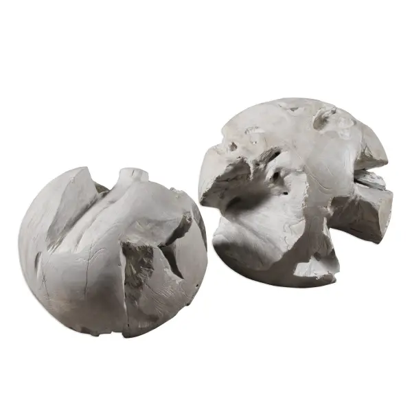 A pair of hand-carved teak spheres finished in a soft gray glaze, perfect for grounding a corner, patio, or balcony with natural, sculptural charm.