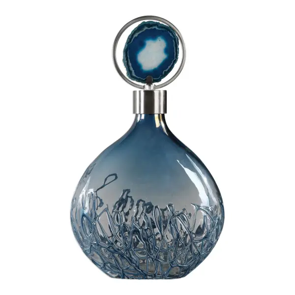 This decorative vase pairs sky blue iridescent glass with a brushed nickel lid and agate stone centerpiece, set within an iron circle frame for a striking tabletop accent.