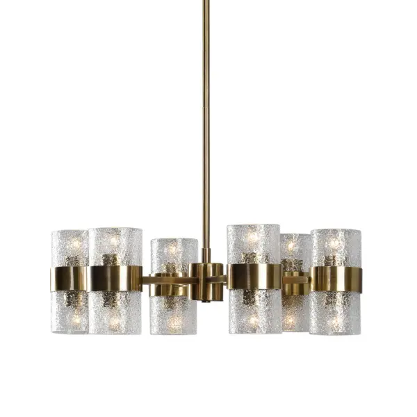 A 12-light Art Deco chandelier in antique brass with thick textured clear glass cylinder shades. Adjustable stems make it flexible for varied ceiling heights.