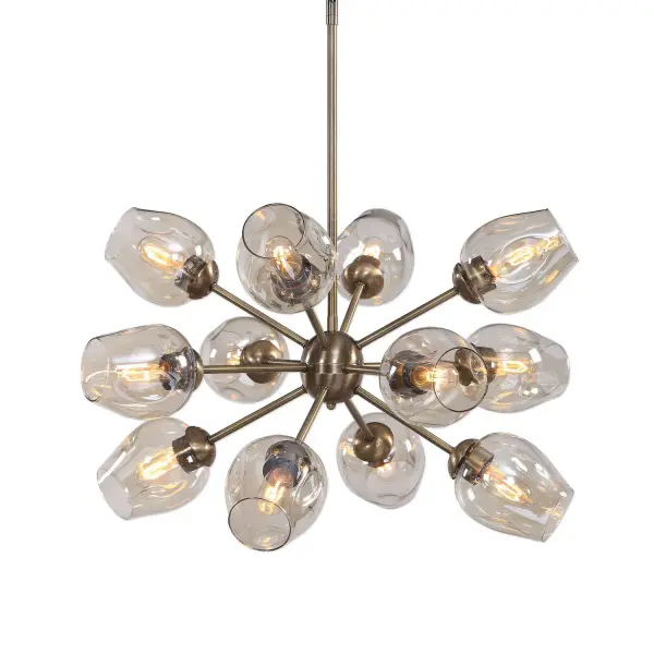 A bold 12-light Sputnik-inspired chandelier in antique brass with amber dimpled glass shades, offering adjustable hanging height and strong visual presence for large rooms.