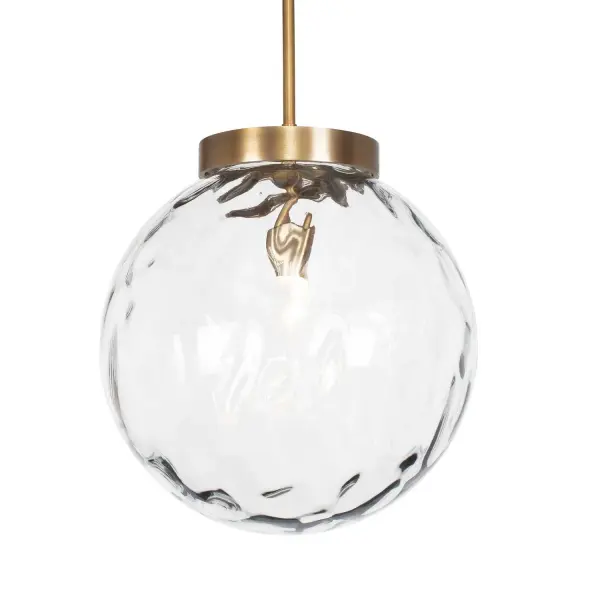 The Gaia pendant pairs an oversized watered glass shade with antique brass hardware for a warm, artisanal accent light that adapts to many ceiling heights.