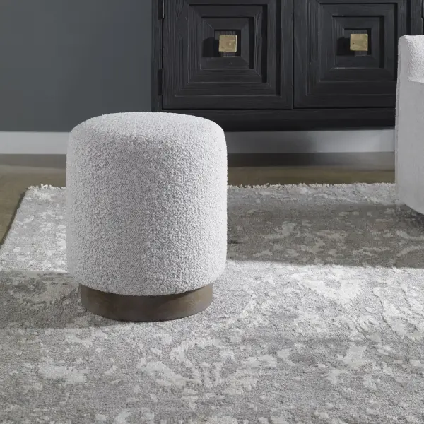 This Plush Ottoman Is Covered In A Casual Ivory And Warm Gray Boucle Fabric With A Natural Walnut Stained Oak Base. Versatile And Stylish, This Piece Can Be Used As A Seat Or Footrest, Grouped Together Or As A Singular Accent Piece. Collection: Avila Finish: Light Gray Width: 16.00" Height: 18.00" Length: 16.00" Weight: 12.10 lb Material: Plywood, Foam, Fabric, Oak Wood Country of Origin: China Safety Rating: Indoor Only