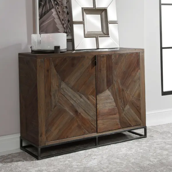 Featuring Abstract Geometric Marquetry Doors In Reclaimed Fir Wood, Sun Faded And Washed In A Walnut Stain, Atop A Forged Iron Base Finished In Aged Gunmetal. Solid Wood Will Continue To Move With Temperature And Humidity Changes, Which Can Result In Cracks And Uneven Surfaces, Adding To Its Authenticity And Character. Collection: Evros Designer: Matthew Williams Finish: Forged Iron Width: 52.00" Height: 39.00" Length: 18.00" Weight: 123.76 lb Material: Reclaimed Fir, Plywood, Iron Country of Origin: China Safety Rating: Indoor Only