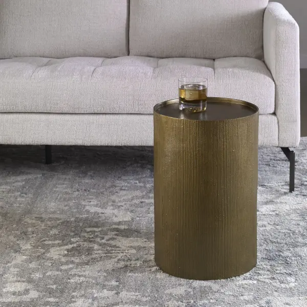 The Adrina Accent Table Features A Versatile Design In Cast Aluminum With A Heavily Textured Reeded Surface Finished In A Beautiful Antique Gold. Collection: Adrina Finish: Antique Gold Width: 12.00" Height: 18.00" Length: 12.00" Weight: 13.00 lb Material: Aluminum Country of Origin: India Safety Rating: Indoor Only