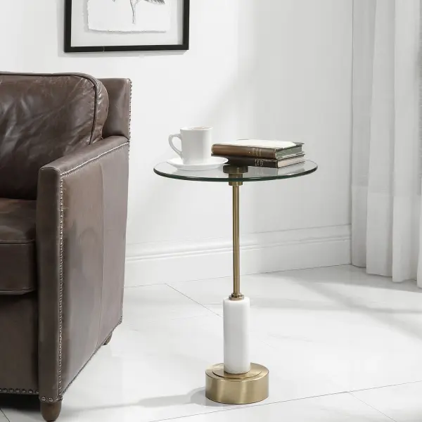 Elegant And Sophisticated, This Round Accent Table Features A Brushed Brass Iron Base With White Marble Details And A Glass Top. Collection: Portsmouth Designer: Jim Parsons Finish: Brushed Brass Width: 15.75" Height: 24.00" Length: 15.75" Weight: 20.90 lb Material: Iron & Marble & Glass Country of Origin: China Safety Rating: Indoor Only