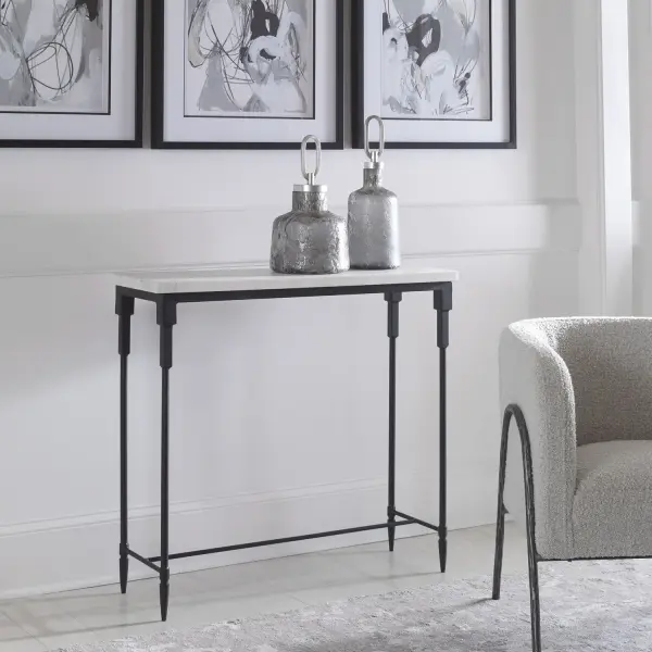 A Classic Black And White Combination With Transitional Style, The Bourges Console Table Features A Honed White Marble Slab Top With An Iron Base In Satin Black. Because Of The Natural Characteristics Of Marble, Each Piece Will Have Unique Veining Patterns. Collection: Bourges Finish: Satin Black Width: 36.00" Height: 34.00" Length: 12.00" Weight: 74.00 lb Material: Marble, Iron Country of Origin: India Safety Rating: Indoor Only