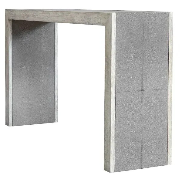 With Modern Elements, This Transitional Console Features Stitched Panels Of Light Gray Faux Shagreen, Paired With A Contrasting Wood Finish In A Aged White With Gray Distressed Details. Collection: Aerina Designer: Matthew Williams Finish: Aged White With Gray Distressed Width: 60.00" Height: 33.00" Length: 15.00" Weight: 67.24 lb Material: Mix Wood With Tsca Title Vi, Faux Shagreen, And Veneer Country of Origin: Indonesia Safety Rating: Indoor Only