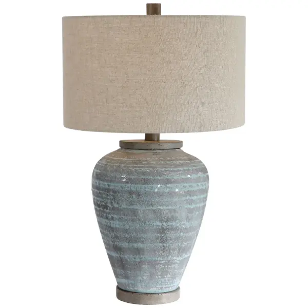 This Table Lamp Design Features A Ceramic Base With A Global, Bohemian Flair, Finished In A Light Aqua Blue Crackle Glaze With A Light Gray Textured Pattern. The Foot And Neck Have A Porous Texture, Finished In A Warm Concrete Look. A Hardback Drum Shade In Beige Linen Fabric With Natural Slubbing Completes This Piece. Collection: Pelia Designer: John Kowalski Finish: Aqua Blue Crackle Glaze With Light Gray Textured Pattern Glass: Round Drum Hardback Width: 17.00" Height: 27.50" Length: 17.00" Weight: 11.70 lb Number of Bulbs: 1 Maximum Wattage: 150.00 W Bulb Type: A Voltage: 110.00 V Material: Ceramic, Resin, Fabric Country of Origin: China Safety Rating: Indoor Only Switch: 3-WAY