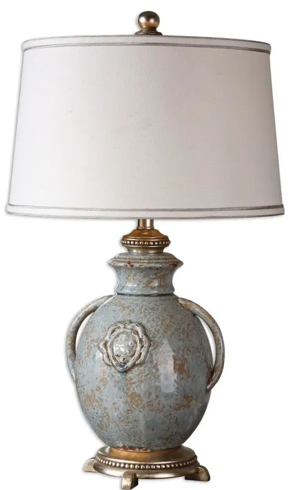 Textured Ceramic Finished In A Distressed Light Blue Glaze With Rust Undertones, Tan Glaze And Silver Leaf Details. The Round, Slightly Tapered Hardback Shade Is Silken Off-white Linen Fabric With Silver Double Trim. Collection: Cancello Designer: Matthew Williams Finish: Light Blue, Rust, Tan and Silver Leaf Glass: Round, Slightly Tapered Hardback Width: 17.00" Height: 28.50" Length: 17.00" Weight: 7.96 lb Extension from Wall: 17.00" Number of Bulbs: 1 Maximum Wattage: 150.00 W Bulb Type: A Voltage: 110.00 V Material: Ceramic, Metal, Resin, Fabric Country of Origin: China Safety Rating: Indoor Only Switch: 3-WAY