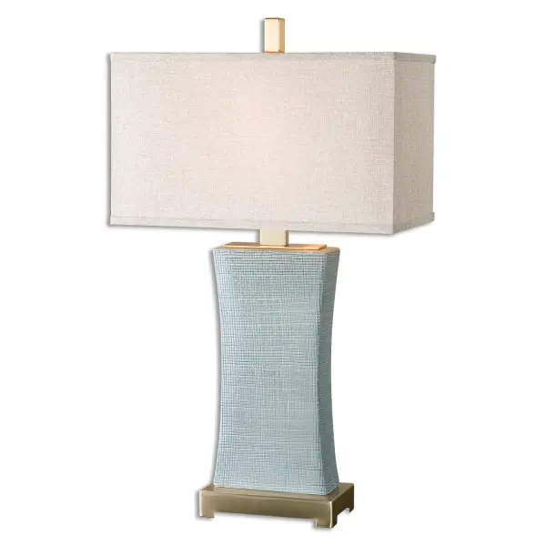 Textured Ceramic Finished In A Pale Blue Gray Glaze Accented With Plated Coffee Bronze Details. The Rectangle Hardback Shade Is A Rust Beige Linen Fabric. Due To The Nature Of Fired Glazes On Ceramic Lamps, Finishes Will Vary Slightly. Collection: Cantarana Designer: Carolyn Kinder Finish: Coffee Bronze, Blue Gray Glaze Glass: Rectangle Hardback Width: 17.00" Height: 29.00" Length: 9.00" Weight: 7.00 lb Number of Bulbs: 1 Maximum Wattage: 100.00 W Bulb Type: A Voltage: 110.00 V Material: Ceramic, Metal, Fabric Country of Origin: China Safety Rating: Indoor Only Switch: ON-OFF