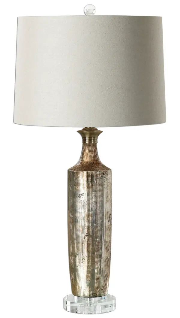 Textured Ceramic Base Finished In A Metallic Bronze Glaze And Paired With Crystal Details And Brushed Nickel Plated Accents. The Slightly Tapered Round Hardback Shade Is A Beige Linen Fabric. Due To The Nature Of Fired Glazes On Ceramic Lamps, Finishes Will Vary Slightly. Collection: Valdieri Designer: Jim Parsons Finish: Metallic Bronze Glass: Slightly Tapered Round Hardback Width: 14.00" Height: 29.50" Length: 15.00" Weight: 6.63 lb Number of Bulbs: 1 Maximum Wattage: 150.00 W Bulb Type: A Voltage: 110.00 V Material: Crystal, Metal, Ceramic, Fabric Country of Origin: China Safety Rating: Indoor Only Switch: 3-WAY