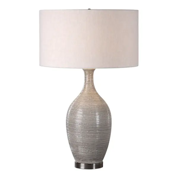 This Ceramic Base Features A Coarse, Horizontal Texture, Finished In A Mushroom Gray Glaze, Accented With Plated Polished Nickel Details. The Round Hardback Drum Shade Is A Light Beige Linen Fabric With Natural Slubbing. Due To The Nature Of Fired Glazes On Ceramic Lamps, Finishes Will Vary Slightly. Collection: Dinah Designer: Jim Parsons Finish: Polished Nickel Glass: Round Hardback Drum Width: 19.00" Height: 31.00" Length: 19.00" Weight: 8.36 lb Number of Bulbs: 1 Maximum Wattage: 150.00 W Bulb Type: A Voltage: 110.00 V Material: Ceramic & Iron Country of Origin: China Safety Rating: Indoor Only Switch: 3-WAY
