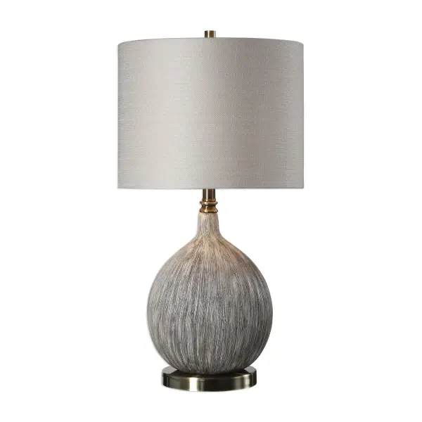 Organic Gourd Shaped Ceramic With A Heavily Textured Surface, Finished In An Old Ivory With Aged Black Undertones, Accented With Burnished Brass Plated Details. The Round Hardback Drum Shade Is A Light Beige Linen Fabric With Natural Slubbing. Collection: Hedera Designer: David Frisch Finish: Burnished Brass Glass: Round Hardback Drum Width: 14.00" Height: 26.50" Length: 14.00" Weight: 7.90 lb Number of Bulbs: 1 Maximum Wattage: 150.00 W Bulb Type: A Voltage: 110.00 V Material: Ceramic & Metal & Fabric Country of Origin: Cambodia Safety Rating: Indoor Only Switch: 3-WAY