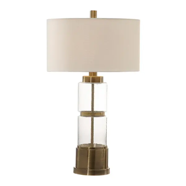 Stacked Clear Glass Columns With A Hammered Texture, Displayed With Antique Brass Plated Steel Details. The Round Hardback Drum Shade Is A White Linen Fabric With White Slubbing. Collection: Vaiga Designer: Jim Parsons Finish: Antique Brass Glass: Round Hardback Drum Width: 17.00" Height: 30.50" Length: 17.00" Weight: 5.10 lb Number of Bulbs: 1 Maximum Wattage: 150.00 W Bulb Type: A Voltage: 110.00 V Material: Steel & Glass & Fabric Country of Origin: China Safety Rating: Indoor Only Switch: 3-WAY