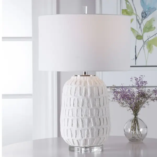 A Modern Take On Old World Style, This Table Lamp Features A Textured, Aged White Ceramic Base With An Organic Grid Design Displayed On A Thick Crystal Foot With Polished Nickel Accents. The Lamp Is Paired With A White Linen Drum Shade. Collection: Caelina Designer: Renee Wightman Finish: Polished Nickel Glass: Drum Hardback Rolled Edge Width: 17.00" Height: 26.50" Length: 17.00" Weight: 19.00 lb Number of Bulbs: 1 Maximum Wattage: 150.00 W Bulb Type: A Voltage: 110.00 V Material: Steel, Ceramic, Crystal, Fabric Country of Origin: China Safety Rating: Indoor Only Switch: 3-WAY