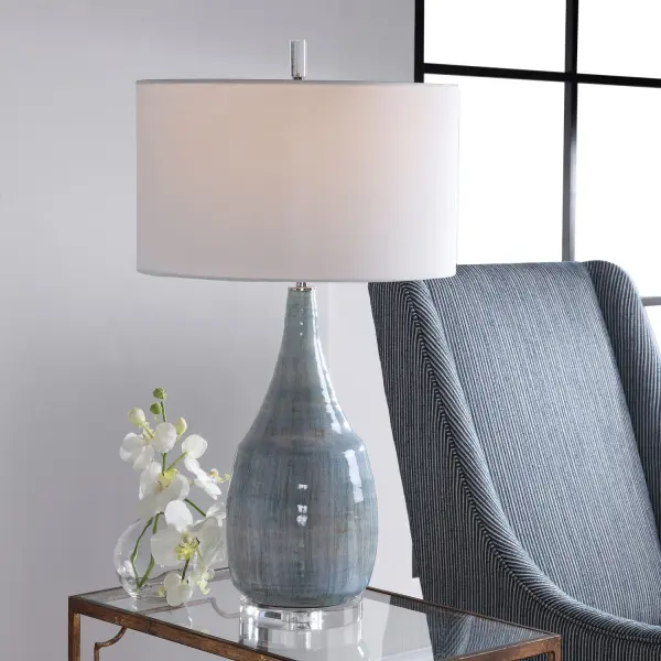Showcasing A Refined Coastal Style, This Table Lamp Has A Ceramic Base Finished In An Aqua And Teal Crackle Glaze With Touches Of Rust Brown. Polished Nickel And Crystal Accents Highlight The Design. The Lamp Is Paired With A Round Hardback Drum Shade In A White Linen Fabric. Collection: Rialta Designer: Jim Parsons Finish: Polished Nickel Glass: Drum Hardback Rolled Edge Width: 17.00" Height: 30.50" Length: 17.00" Weight: 15.20 lb Number of Bulbs: 1 Maximum Wattage: 150.00 W Bulb Type: A Voltage: 110.00 V Material: Steel & Ceramic & Crystal Country of Origin: China Safety Rating: Indoor Only Switch: 3-WAY