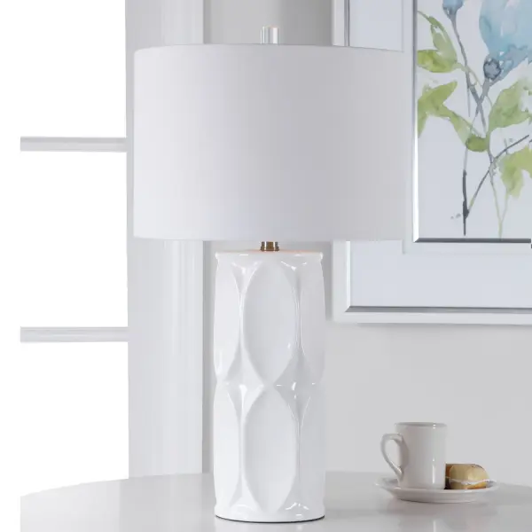 This Ceramic Table Lamp Showcases A Touch Of Mid-century Style With A Dimensional Geometric Design Finished In A Glossy White Glaze, Accented With Brushed Nickel Neck And A Crystal Finial. The Lamp Is Paired With A White Fabric Drum Shade. Collection: Sinclair Designer: David Frisch Finish: Brushed Nickel Glass: Round Drum Hardback Shade Width: 15.00" Height: 26.00" Length: 15.00" Weight: 6.38 lb Number of Bulbs: 1 Maximum Wattage: 150.00 W Bulb Type: A Voltage: 110.00 V Material: Ceramic & Metal & Fabric Country of Origin: China Safety Rating: Indoor Only Switch: 3-WAY