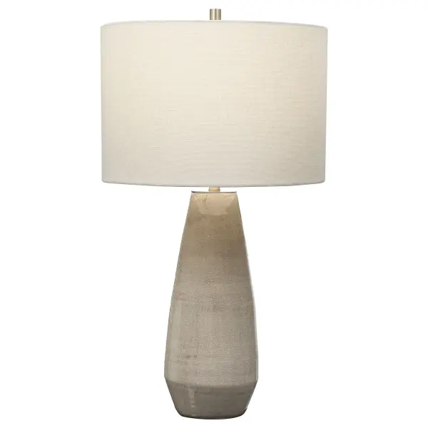 Simple Yet Stylish, This Ceramic Table Lamp Is Finished In A Crackled Taupe-gray Glaze With Noticeable Distressed Details And Antique Brushed Brass Accents. The Round Hardback Drum Shade Is A White Linen Fabric. Collection: Volterra Designer: Osvaldo Mendoza Finish: Antique Brushed Brass Glass: Round Drum Hardback Width: 15.00" Height: 27.50" Length: 15.00" Weight: 9.00 lb Number of Bulbs: 1 Maximum Wattage: 150.00 W Bulb Type: A Voltage: 110.00 V Material: Ceramic, Steel Country of Origin: China Safety Rating: Indoor Only