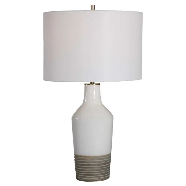 This Ceramic Lamp Features A White Crackle Glaze Finish Paired With A Ribbed Textured Bottom Half Finished In An Aged Terracotta Tone, Accented By Light Antique Brushed Brass Details. A Simple White Linen Fabric Drum Shade Complements The Piece. Collection: Dakota Designer: Osvaldo Mendoza Finish: Antique Brushed Brass Glass: Round Drum Hardback Width: 15.00" Height: 26.50" Length: 15.00" Weight: 9.00 lb Number of Bulbs: 1 Maximum Wattage: 150.00 W Bulb Type: A Voltage: 110.00 V Material: Ceramic, Steel Country of Origin: China Safety Rating: Indoor Only