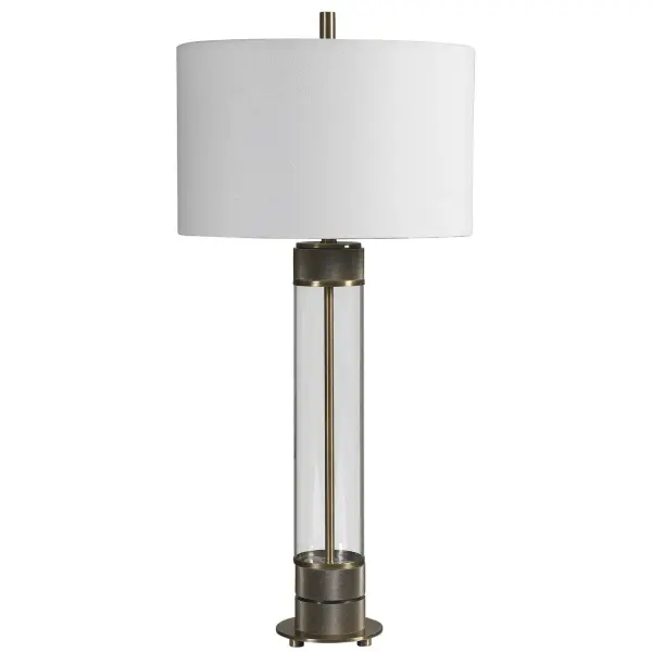 Showcasing A Clean Transitional Look, This Table Lamp Features A Clear Glass Base Accented With Antiqued Brass Plated, Heavy Textured Iron Details For A Soft Industrial Feel. The Lamp Is Paired With A White Fabric Drum Shade. Collection: Anmer Designer: John Kowalski Finish: Antiqued Brass Glass: Round Drum Hardback Shade Width: 16.00" Height: 35.00" Length: 16.00" Weight: 13.00 lb Number of Bulbs: 1 Maximum Wattage: 150.00 W Bulb Type: A Voltage: 110.00 V Material: Iron & Glass & Fabric Country of Origin: Vietnam Safety Rating: Indoor Only