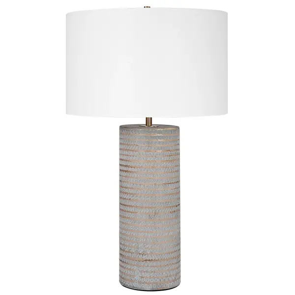 This Ceramic Table Lamp Showcases A Rustic Chiseled Texture With Frosted Pewter Gray Undertones And Organic Carved Accents In Light Sepia Tones. Iron Details Are Finished In Antique Brass. The Lamp Is Complimented By A White Fabric Drum Shade. Collection: Monolith Designer: John Kowalski Finish: Antique Brass Glass: Round Drum Hardback Width: 16.00" Height: 28.50" Length: 16.00" Weight: 7.70 lb Number of Bulbs: 1 Maximum Wattage: 150.00 W Bulb Type: A Voltage: 110.00 V Material: Ceramic, Iron, Fabric Country of Origin: China Safety Rating: Indoor Only