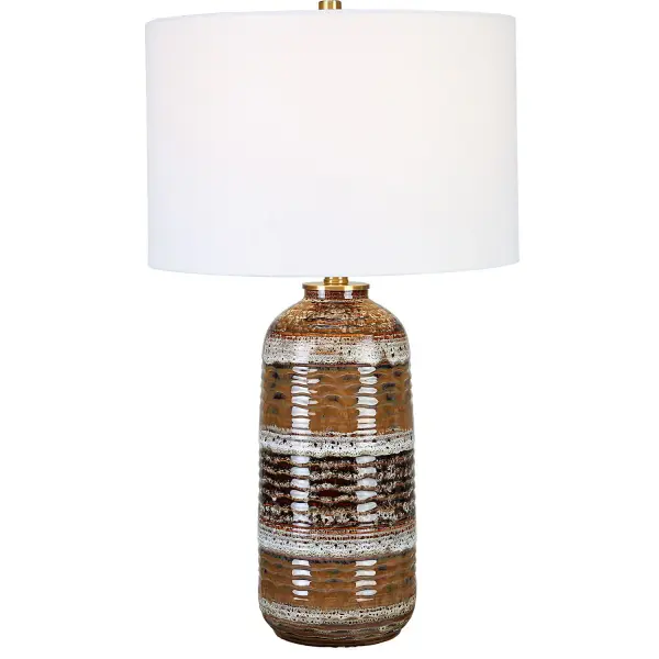 Natural Clay, Taupe, White, And Charcoal Tones Work Together To Create A Unique Artisan-crafted Look For This Table Lamp. The Ceramic Base Is Accented By Antique Brass Finished Details. The Hardback Drum Shade Is Covered In A White Linen Fabric. Glaze Colors And Designs May Vary Slightly Adding To The Authenticity And Character Of The Piece. Collection: Roan Designer: David Frisch Finish: Antique Brass Glass: Round Drum Hardback Shade Width: 15.50" Height: 26.50" Length: 15.50" Weight: 6.60 lb Number of Bulbs: 1 Maximum Wattage: 100.00 W Bulb Type: A Voltage: 110.00 V Material: Metal, Ceramic, Fabric Country of Origin: China Safety Rating: Indoor Only