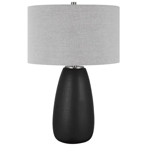 The Twilight Table Lamp Features A Ceramic Base With A Subtle Carved Gridline Texture, Finished In A Satin Black Glaze And Accented By Brushed Nickel Plated Details. The Hardback Drum Shade Is Covered In A Light Gray Linen Fabric. Collection: Twilight Designer: Osvaldo Mendoza Finish: Brushed Nickel Glass: Round Hardback Drum Width: 17.00" Height: 27.25" Length: 17.00" Weight: 8.00 lb Number of Bulbs: 1 Maximum Wattage: 150.00 W Bulb Type: A Voltage: 110.00 V Material: Steel, Ceramic, Fabric Country of Origin: China Safety Rating: Indoor Only