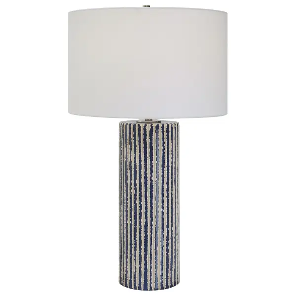 This Ceramic Table Lamp Features Eye-catching, Crudely Carved, Cobalt Glazed Stripes With Contrasting Ivory, Accented With Brushed Nickel Details. The Round Hardback Shade Is Covered In A White Fabric. Collection: Havana Designer: Carolyn Kinder Finish: Brushed Nickel Glass: Round Hardback Drum Width: 16.00" Height: 27.50" Length: 16.00" Weight: 8.00 lb Number of Bulbs: 1 Maximum Wattage: 150.00 W Bulb Type: A Voltage: 110.00 V Material: Ceramic, Iron, Fabric Country of Origin: China Safety Rating: Indoor Only