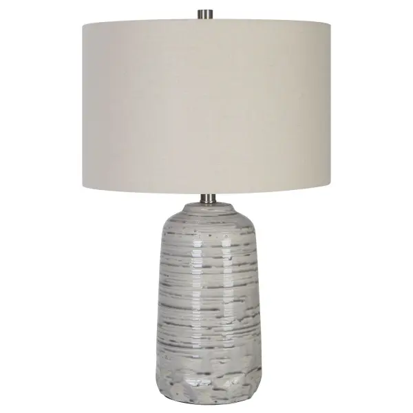 This Ceramic Table Lamp Has A Unique Shape Featuring A Traditional Style Urn Body That Has Cut Edges At The Bottom For A Subtle Contemporary Flair, Finished In An Ivory Glaze With A Heavy Striped Gray Drip And Brushed Nickel Plated Accents. The Lamp Is Complemented By A Hardback Drum Shade In A Light Beige Linen Fabric With Natural Slubbing. Collection: Cyclone Designer: Carolyn Kinder Finish: Brushed Nickel Glass: Round Hardback Drum Width: 16.00" Height: 24.75" Length: 16.00" Weight: 7.00 lb Number of Bulbs: 1 Maximum Wattage: 150.00 W Bulb Type: A Voltage: 110.00 V Material: Ceramic, Iron, Fabric Country of Origin: China Safety Rating: Indoor Only