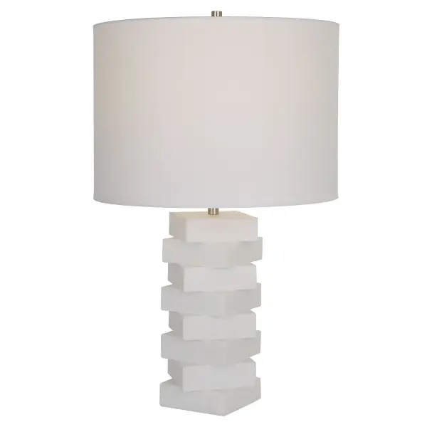 The Ascent Table Lamp Showcases A Unique Geometric Design With Alternating Stacked Blocks Constructed From A Man-made Ivory Stone That Accurately Replicate The Look Of Thassos Marble. Iron Details Are Finished In A Plated Brushed Nickel, Paired With A White Hardback Drum Shade. Collection: Ascent Finish: Brushed Nickel Glass: Round Hardback Drum Width: 14.00" Height: 23.00" Length: 14.00" Weight: 6.00 lb Number of Bulbs: 1 Maximum Wattage: 150.00 W Bulb Type: A Voltage: 110.00 V Material: Rice Stone, Iron, Linen Country of Origin: China Safety Rating: Indoor Only