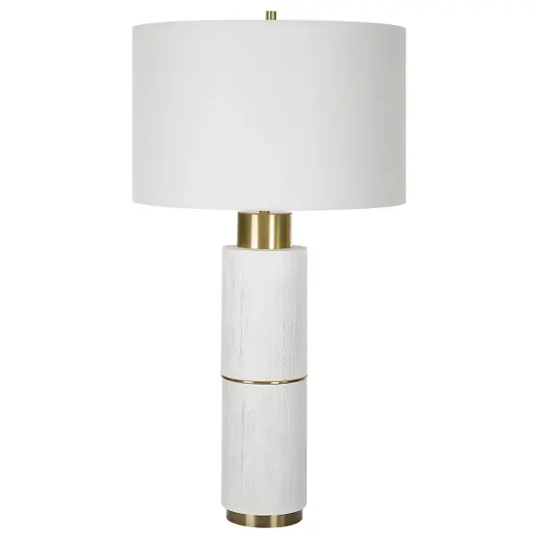 The Ruse Table Lamp Showcases A Whitewashed Wood Look With A Noticeable Textured Finish, Accented By Brushed Brass Plated Iron Details. Paired With A Hardback Drum Shade In A White Linen Fabric. Collection: Ruse Designer: David Frisch Finish: Brushed Brass Glass: Round Drum Hardback Shade Width: 16.00" Height: 30.00" Length: 16.00" Weight: 9.30 lb Number of Bulbs: 1 Maximum Wattage: 150.00 W Bulb Type: A Voltage: 110.00 V Material: Resin , Iron , Fabric Country of Origin: China Safety Rating: Indoor Only
